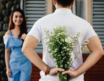 couple man giving flowers to woman