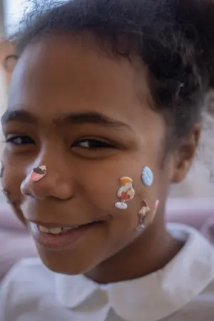 girl with stickers on face