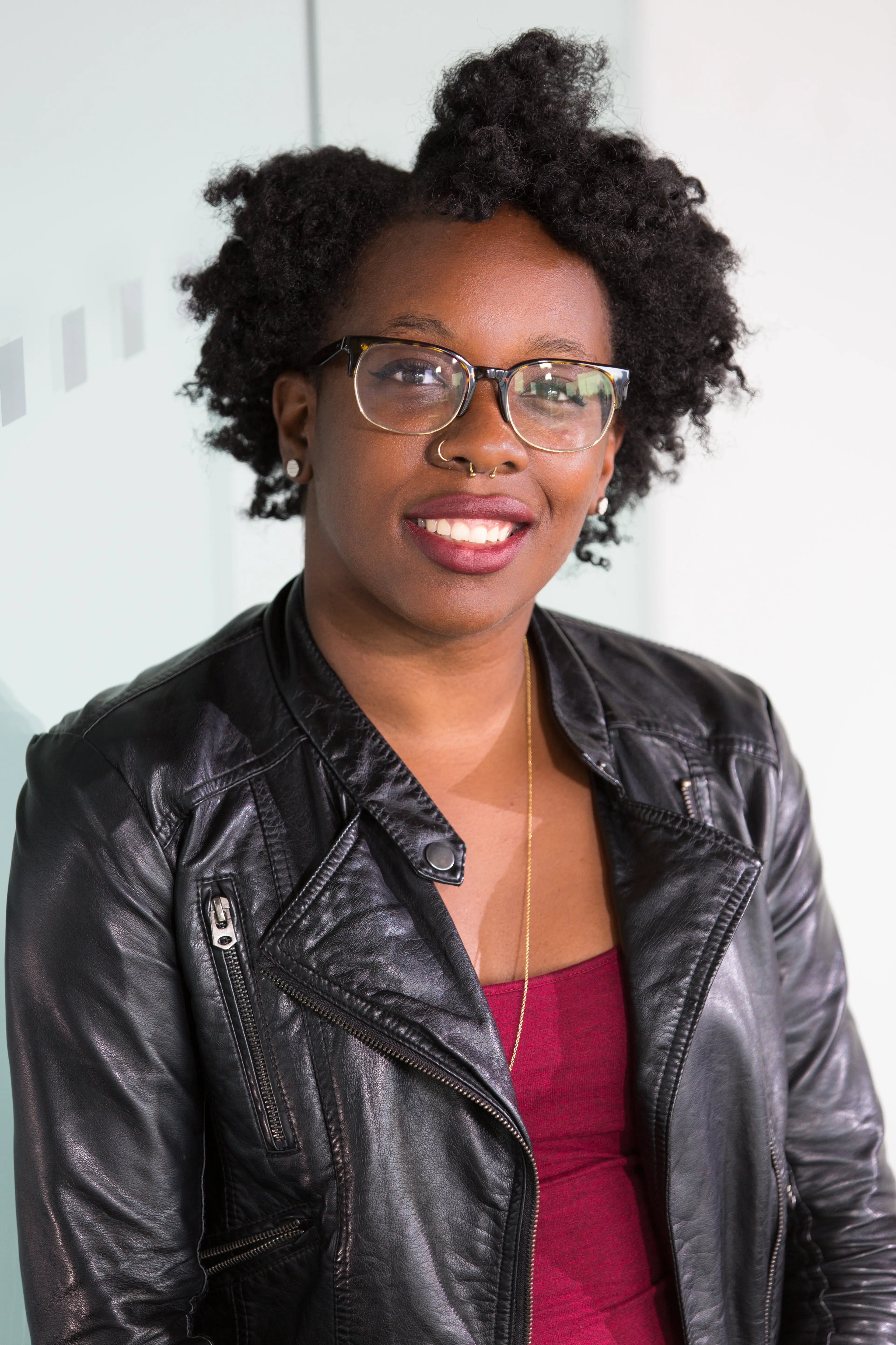 woman wearing leather jacket over dress